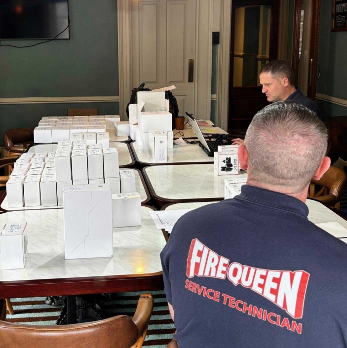 Engineer fitting wireless fire alarm – “Certified fire alarm engineer installing wireless fire alarm system UK.”
